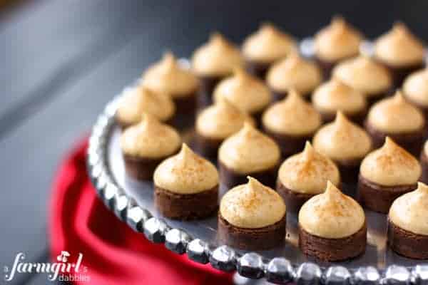 espresso brownie bites topped with kahlua buttercream on a silver cake stand