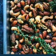 pinterest image of Rosemary Thyme Spiced Nuts with fresh sprigs of thyme