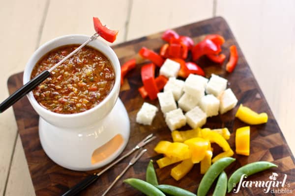 a fondue pot of bagna cauda with with fresh vegetables