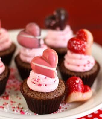 brownie bites topped with strawberry frosting and a truffle