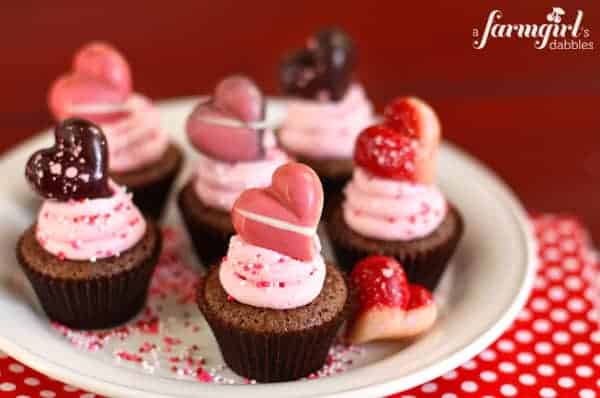 brownie bites topped with strawberry frosting and a truffle