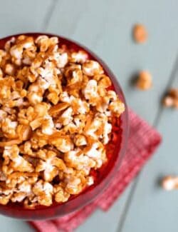 a red bowl of cinnamon caramel corn