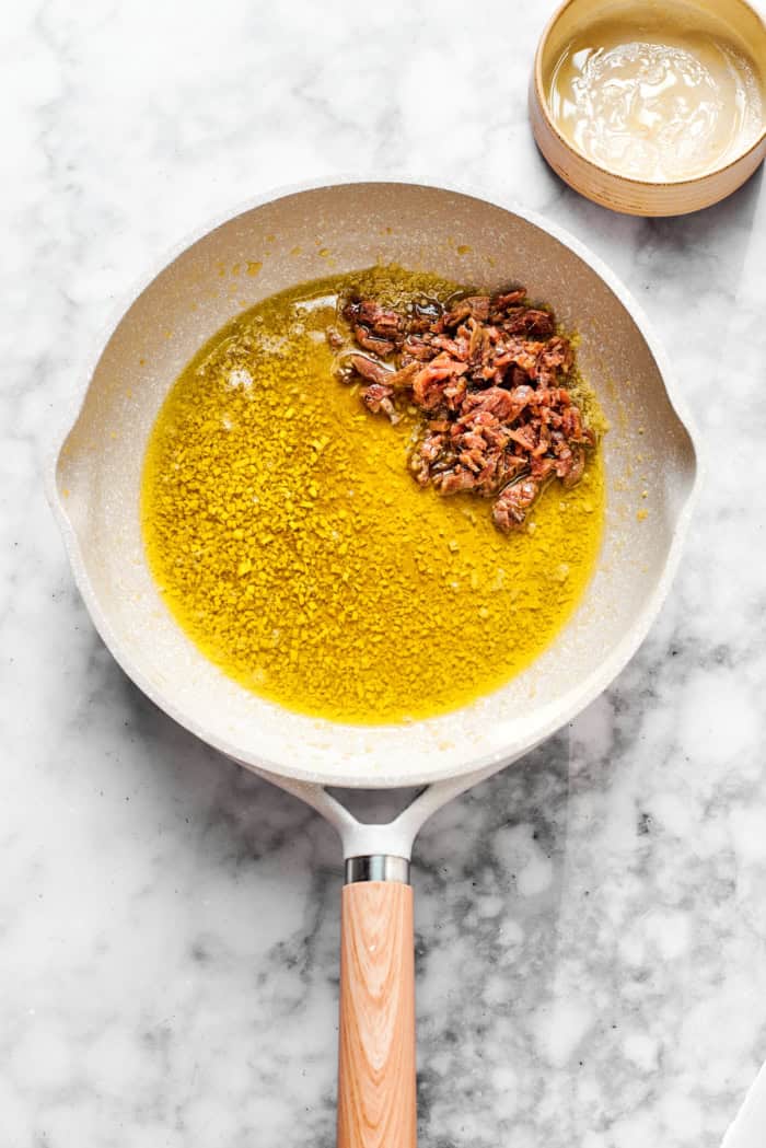Anchovies in pan with garlic and olive oil