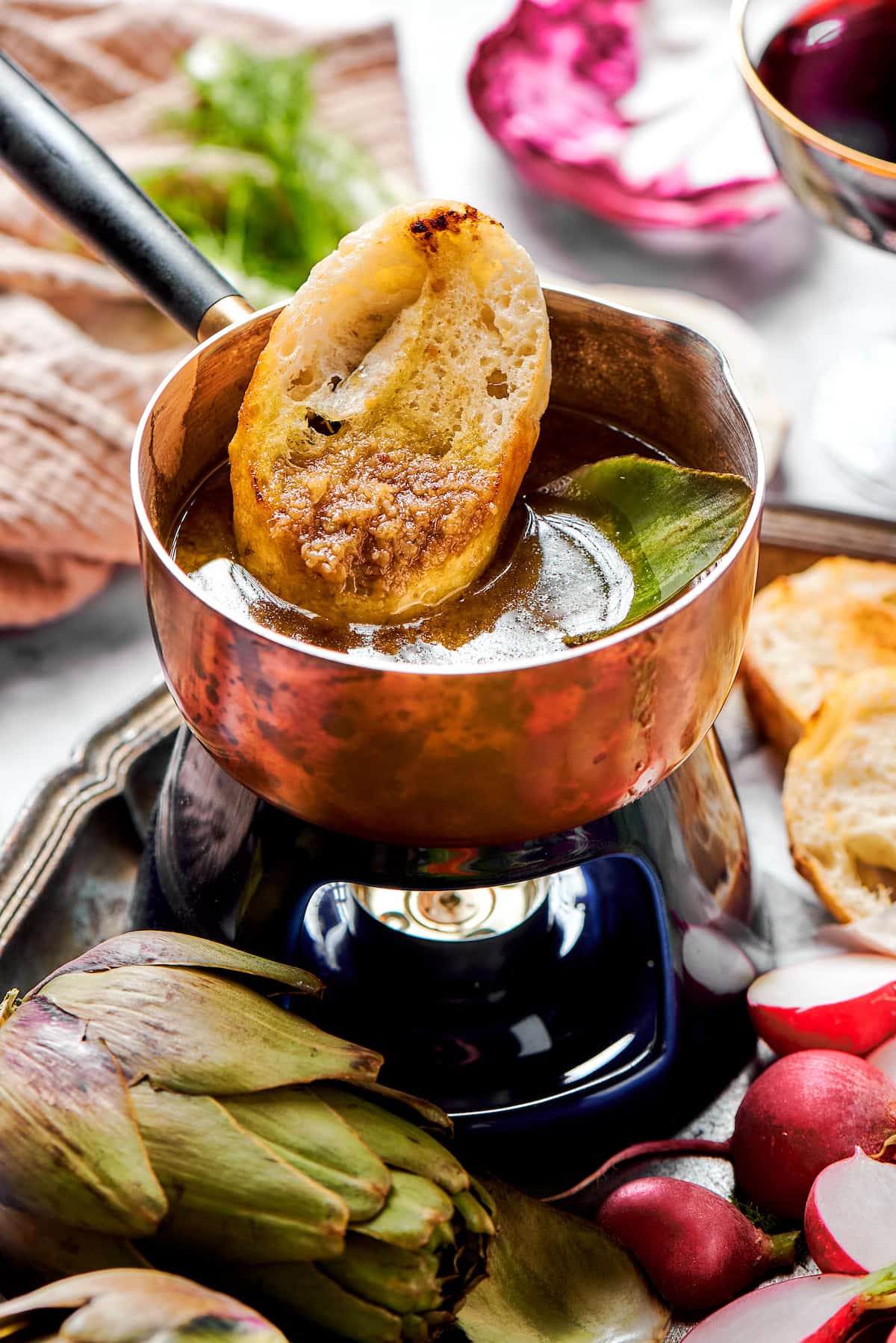 Dipping bread into bagna cauda sauce