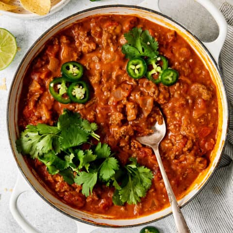 Overhead view of cheesy beef taco dip in a skillet