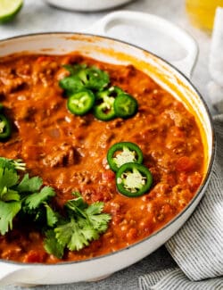 Cheesy ground beef taco dip topped with sliced jalapenos