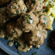 pinterest image of swedish meatballs on a plate with mashed potatoes