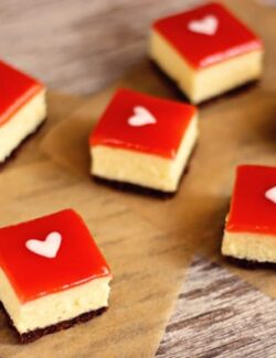 white chocolate cheesecake squares topped with strawberry glaze and a white heart