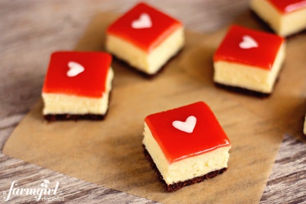 white chocolate cheesecake squares with strawberry glaze