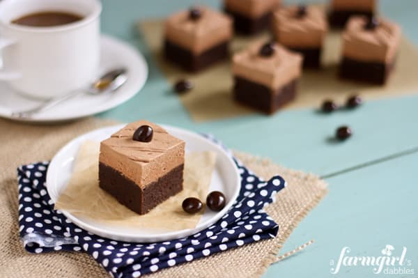 brownie squares topped with mocha buttercream and a chocolate covered coffee bean