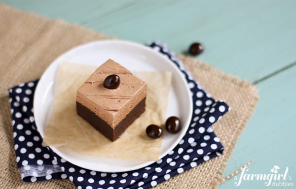 brownies with mocha buttercream on a white plate