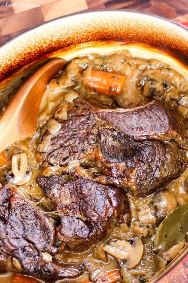 a large crockpot of Pot Roast with Mushrooms, Carrots, and Onions