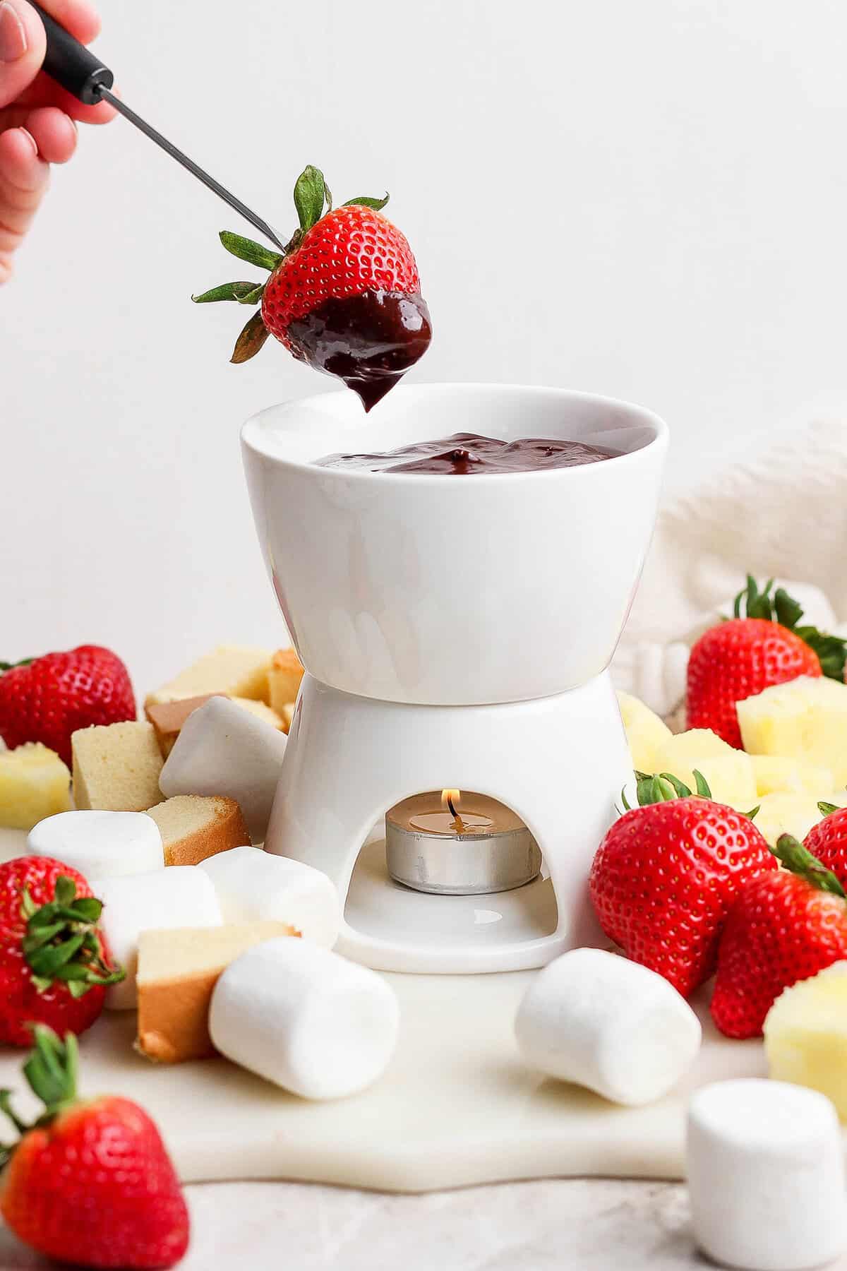 A secret ingredient makes this easy Chocolate Fondue the best ever! It’s rich, decadent and thick enough to stick to all your dippers. Strawberry dipped into chocolate fondue