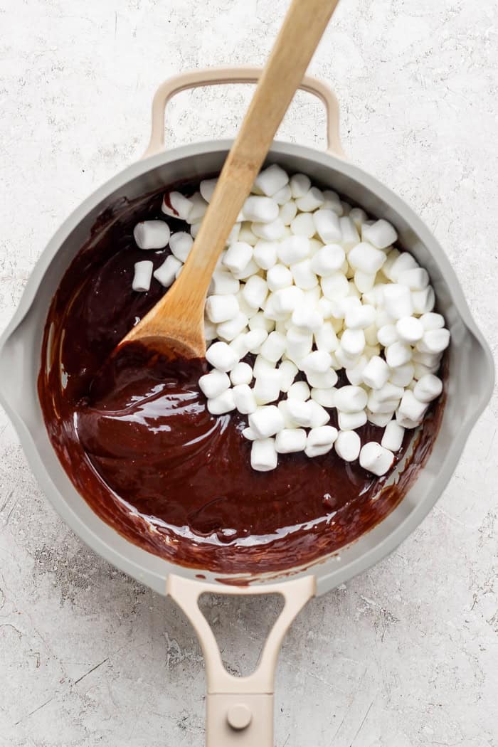Stirring marshmallows into chocolate fondue