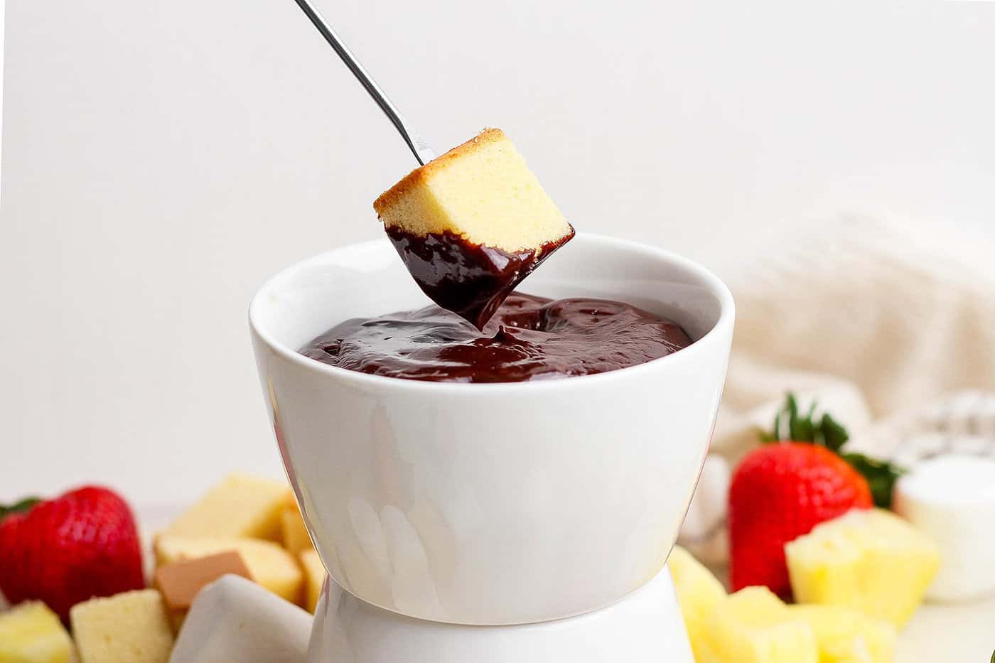 Dipping poundcake into chocolate fondue