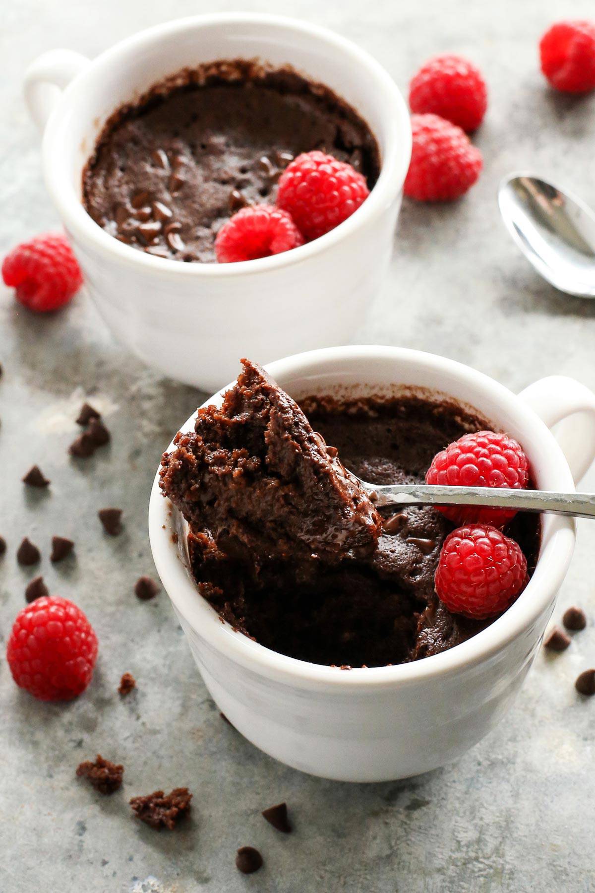 a spoon of chocolate cake out of a white mug