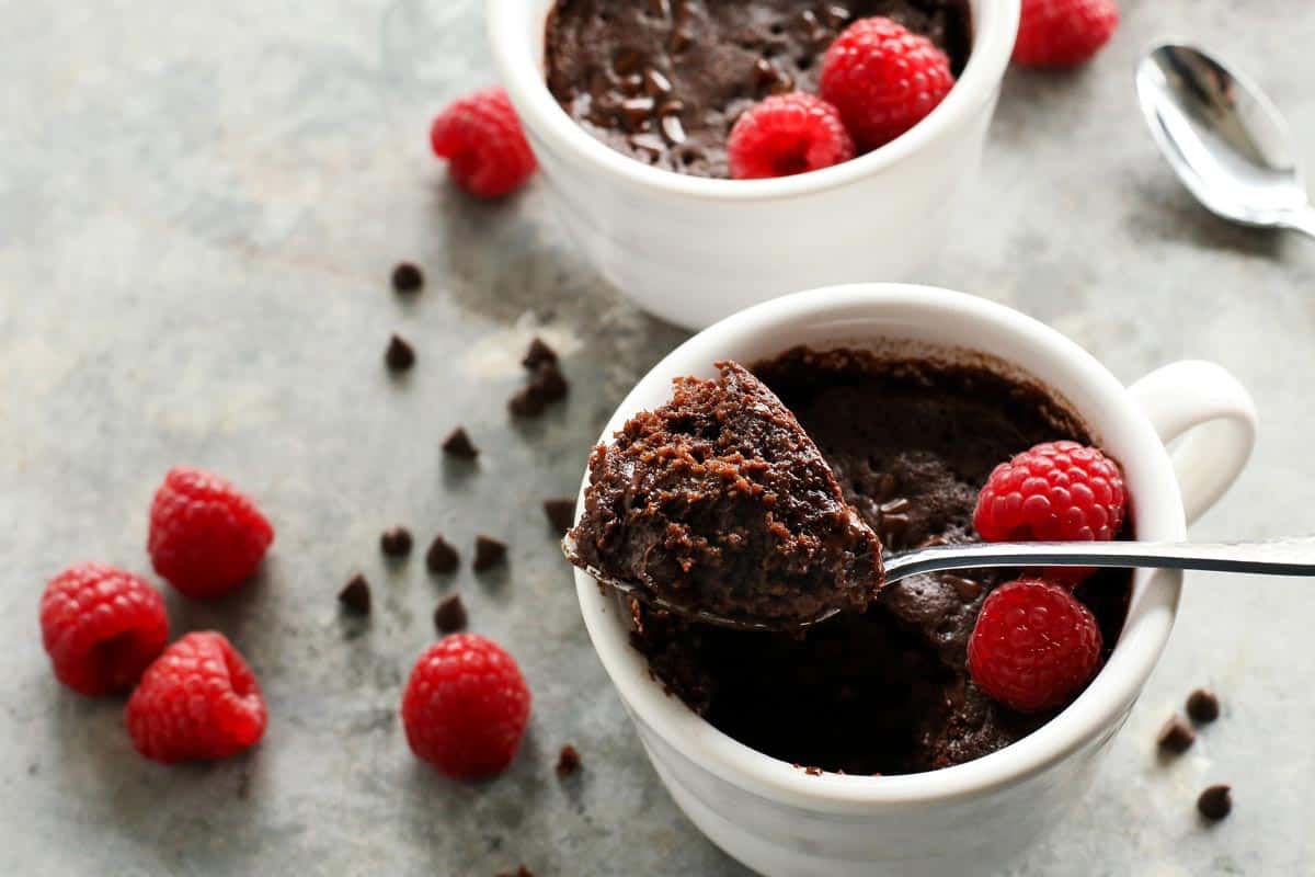 a spoonful of chocolate cake from a mug