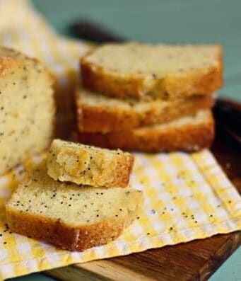 slices of almond poppy seed bread on a wooden cutting boar