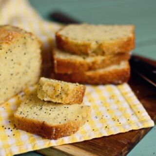 Almond Poppy Seed Bread on a Yellow Checkered Dish Towel
