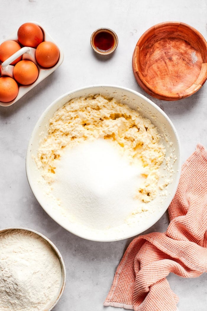 Sugar added to creamed butter and cream cheese.