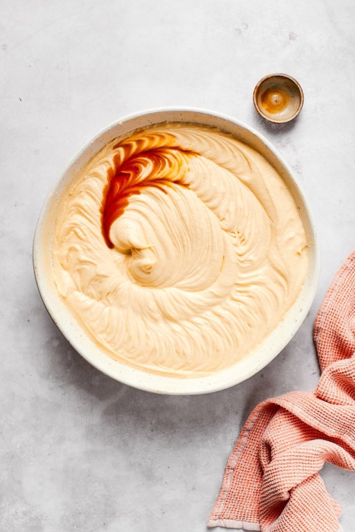 Vanilla extract added to bowl of cake batter.