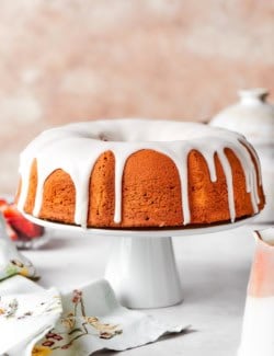 Whole cream cheese pound cake on cake stand.