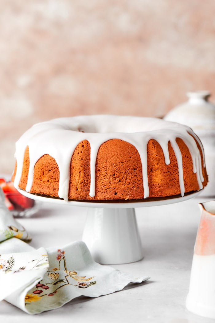 Whole cream cheese pound cake on cake stand.