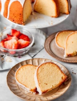 Two plates with two slices of cream cheese pound cake.
