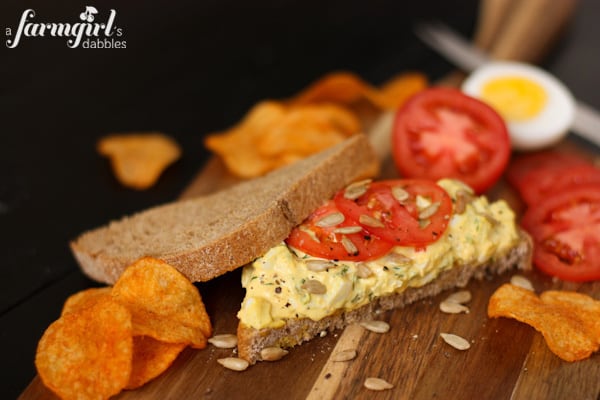 and herby egg salad sandwich and tomato slices