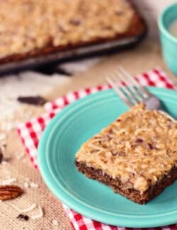 a slice of German chocolate sheet cake on a blue plate