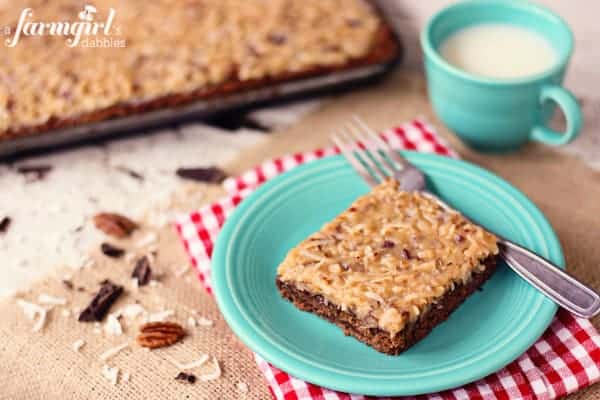 a slice of German chocolate sheet cake on a blue plate