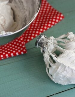 a large mixing bowl and beater of homemade marshmallow cream