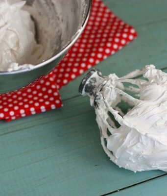 a large mixing bowl and beater of homemade marshmallow cream