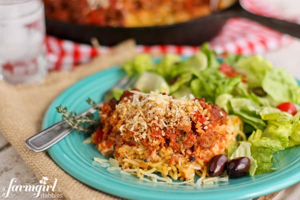 a plate with salad and spaghetti