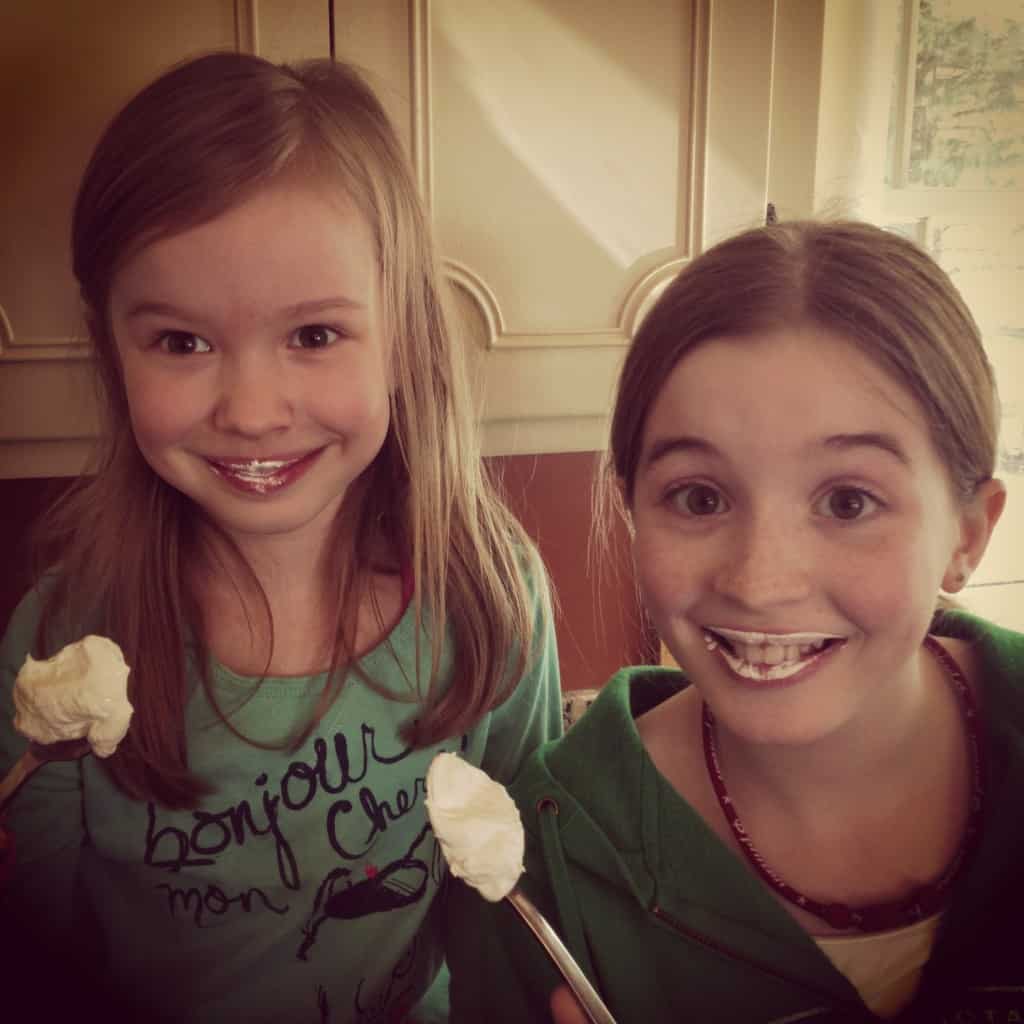 two girls eating marshmallow cream