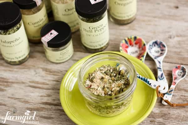 a jar of Homemade Green Taco Seasoning and different spices