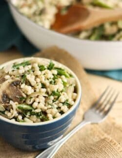 A blue bowl of Couscous with Mushrooms, Shallots, and Asparagus