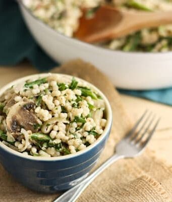 A blue bowl of Couscous with Mushrooms, Shallots, and Asparagus
