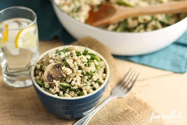 a blue bowl of Couscous with Mushrooms, Shallots, and Asparagus