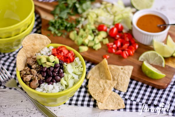 rice bowls with ground turkey, lettuce, beans, and tomatoes