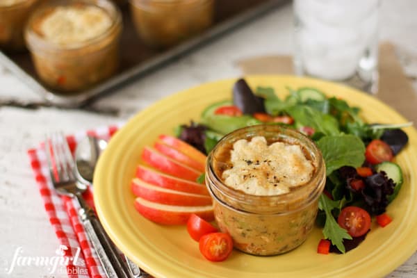 an individual chicken pot pie with sliced apple and a side salad