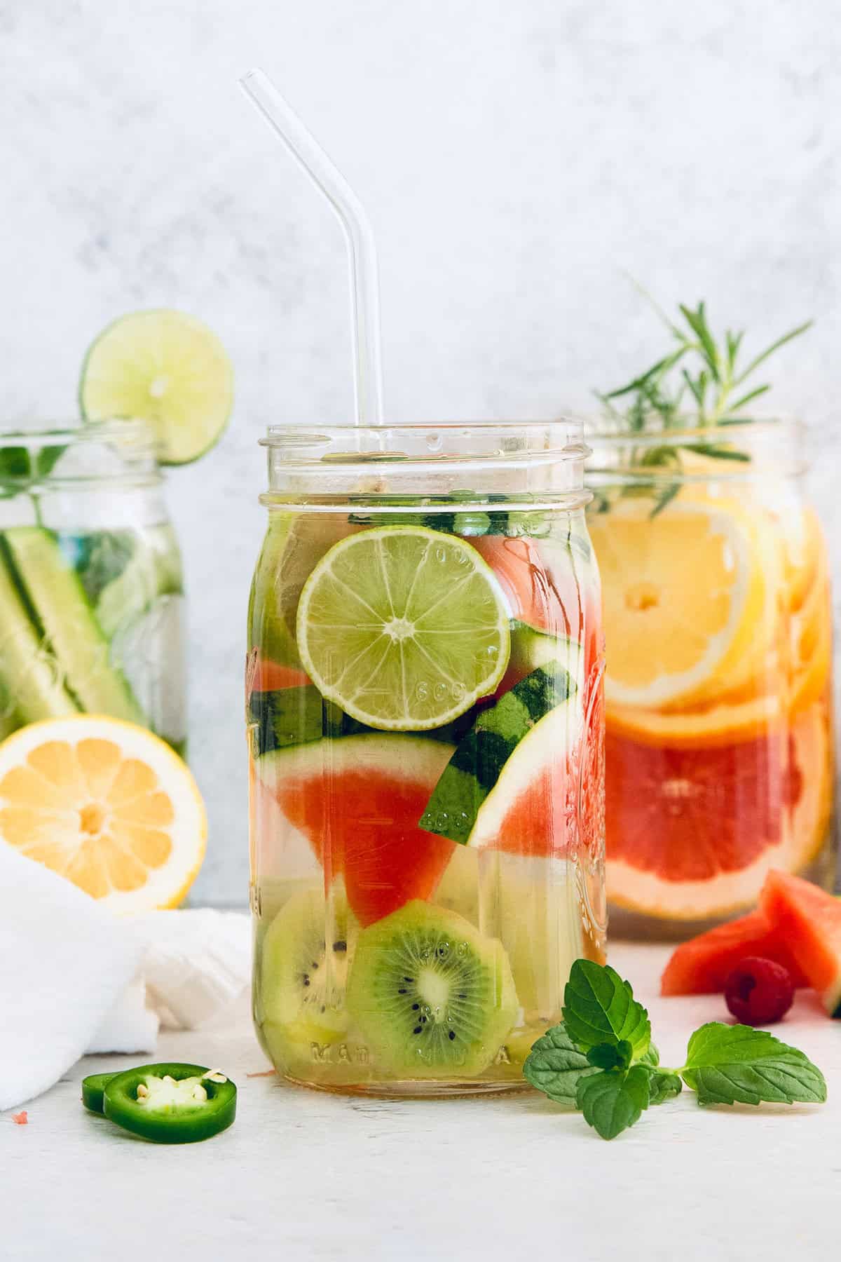 Six delicious flavor ideas for making infused spa water at home. Put extra herbs and fruit to use and make staying hydrated so much tastier! Jars of spa water with fresh fruit and herbs