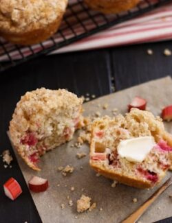 a Rhubarb Muffins sliced in half spread with butter