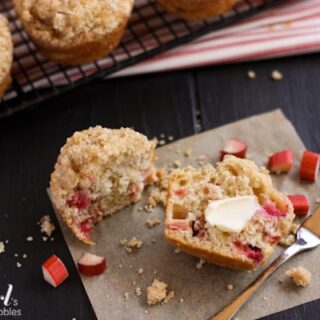 a Rhubarb Muffins sliced in half spread with butter