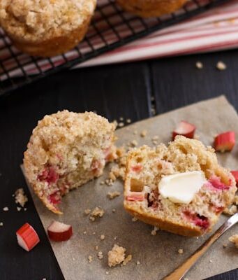 a Rhubarb Muffins sliced in half spread with butter