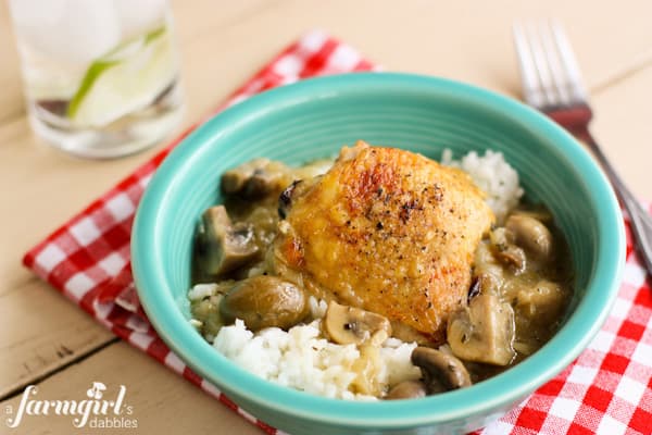 Braised Chicken and Mushrooms in a blue bowl with rice