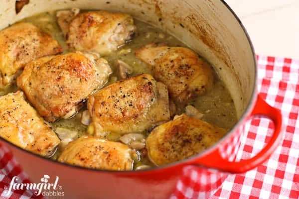 a red crockpot of Braised Chicken with Mushrooms and Green Olives
