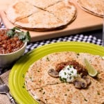 This easy veggie quesadilla recipe is cheesy and topped with mushrooms and herbs.