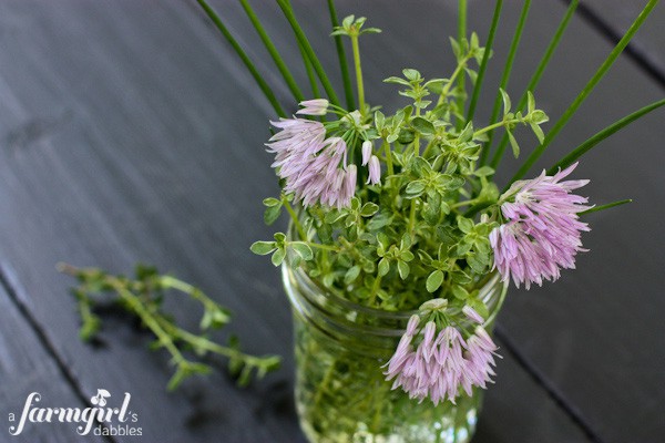 thyme and chives in a glass jar