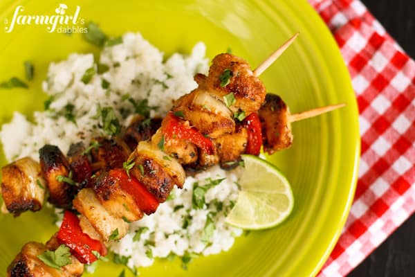 a green plate with rice and Grilled Chicken Kebabs